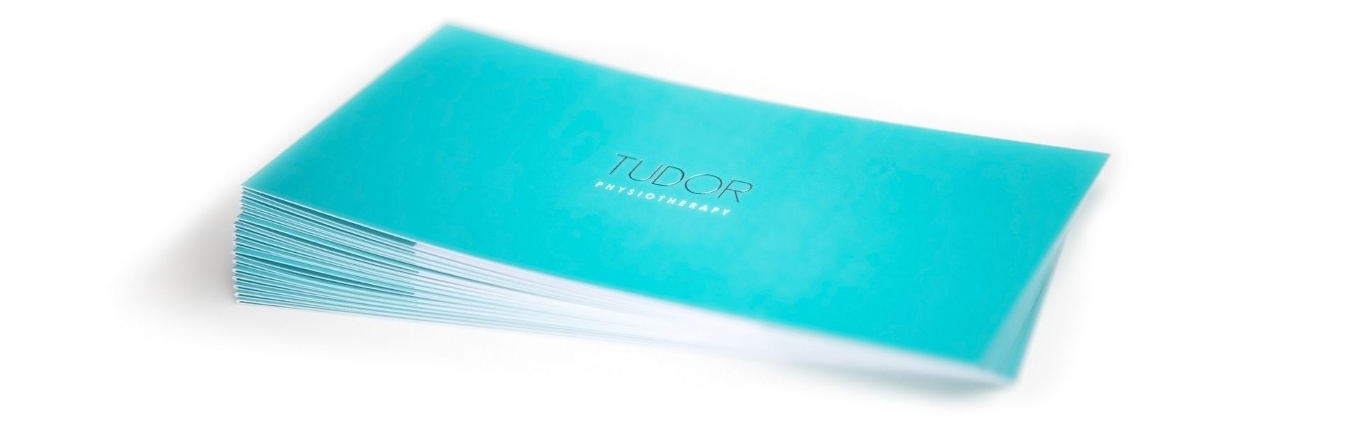 a stack of blue brochures for tudor physiotherapy