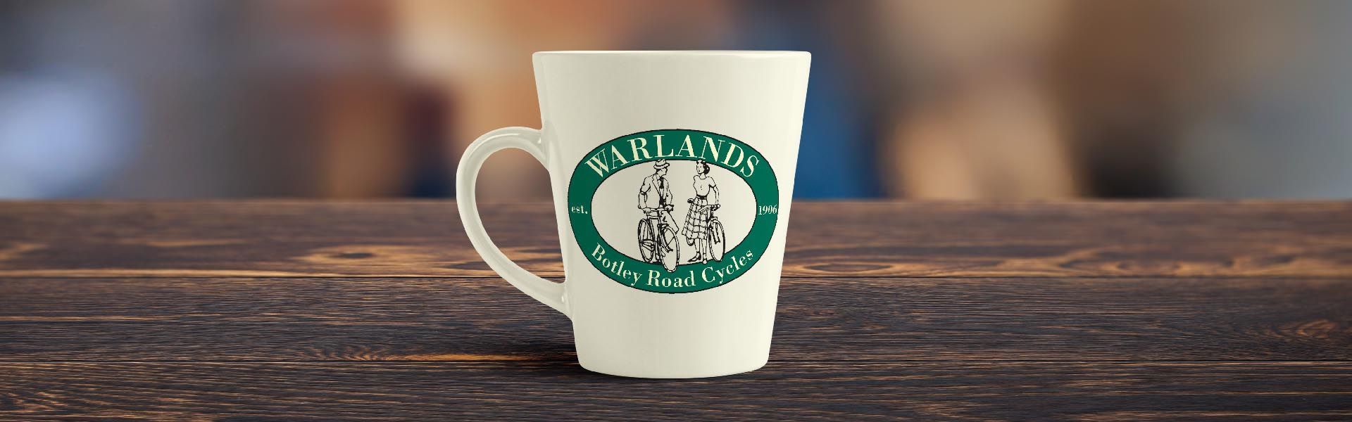 a tall coffee mug with the warlands logo on it