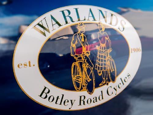 the logo for warlands botley road cycles is on a car.