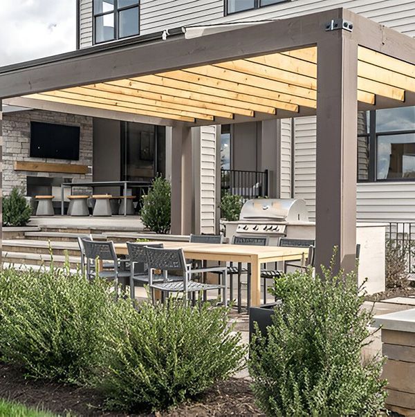 A patio with a table and chairs under a pergola.