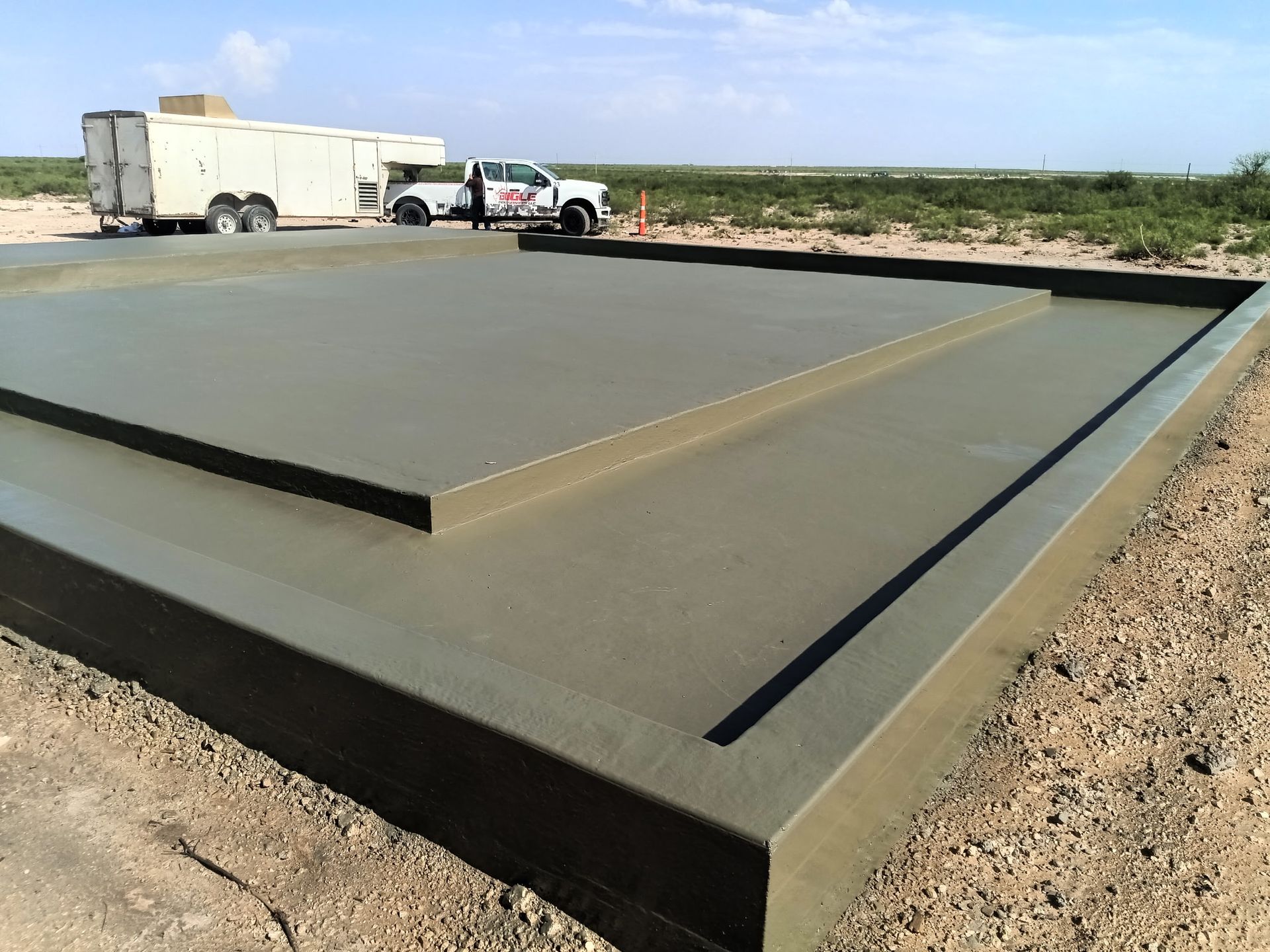 A truck is parked on the side of a concrete slab