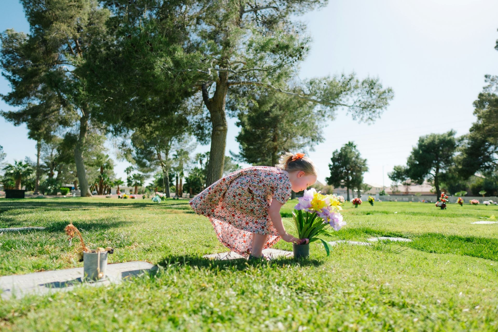 Couple on beach, embracing, looking at the ocean at sunset.
