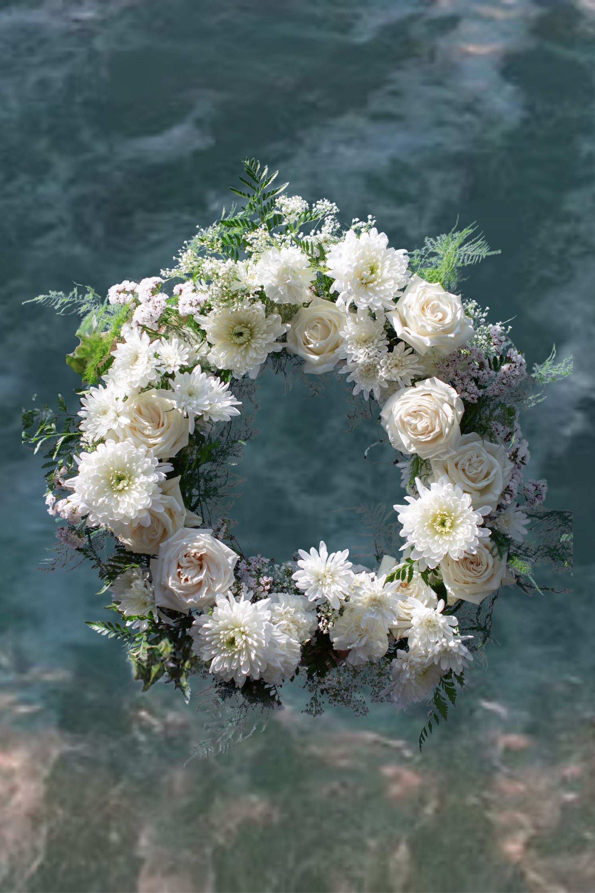 Wreath of flowers in a metal holder on a boat, prepared to be released.