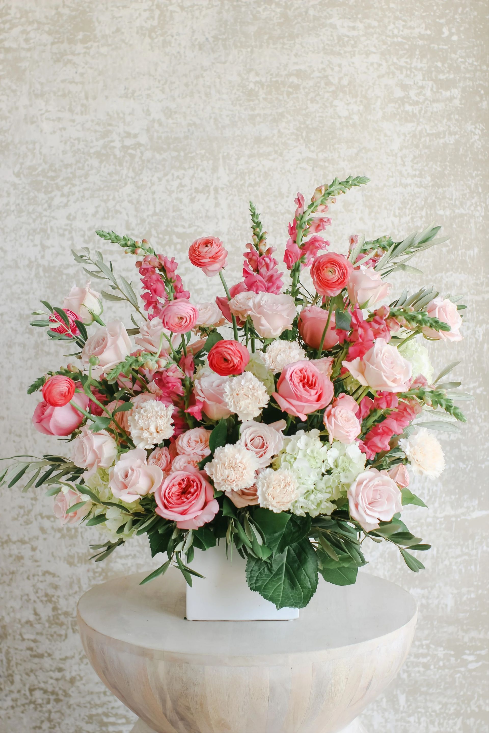 Bouquet of colorful tropical flowers: red ginger, orange heliconia, pink and purple orchids, ferns.