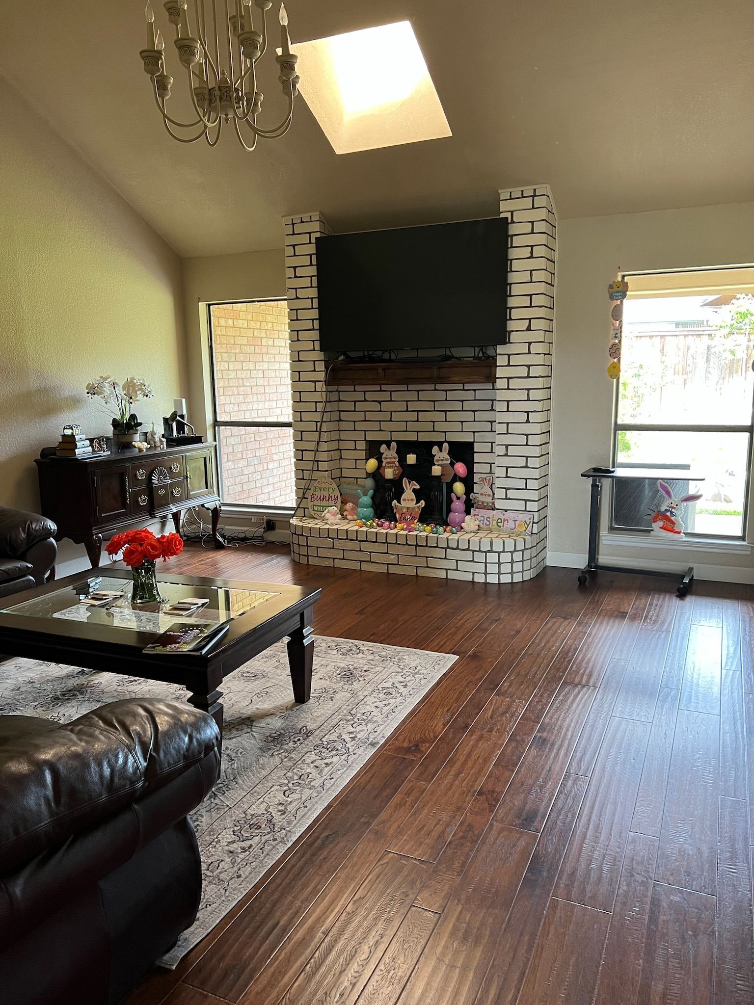 A living room with a fireplace and a flat screen tv.