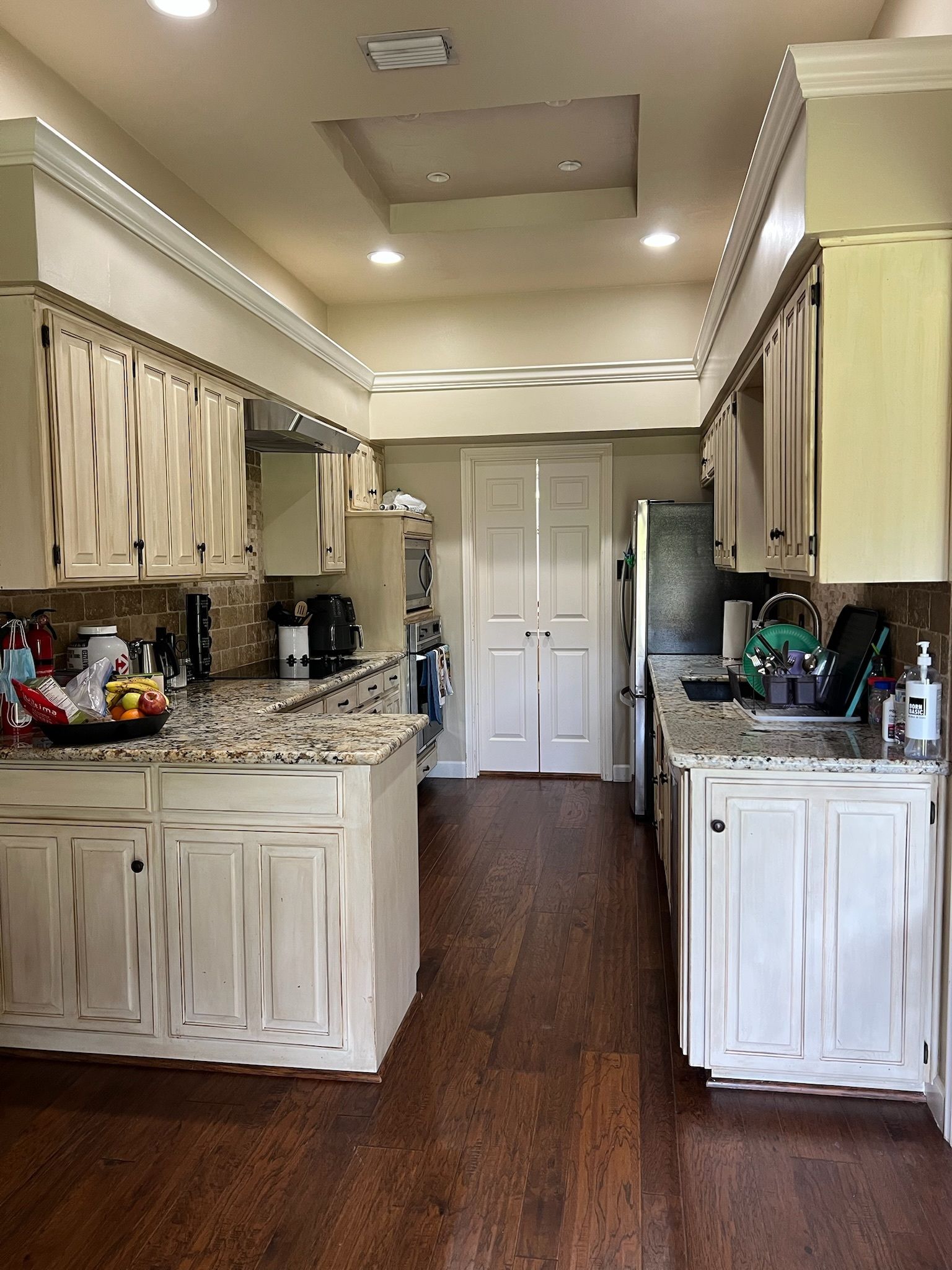 A kitchen with white cabinets and granite counter tops