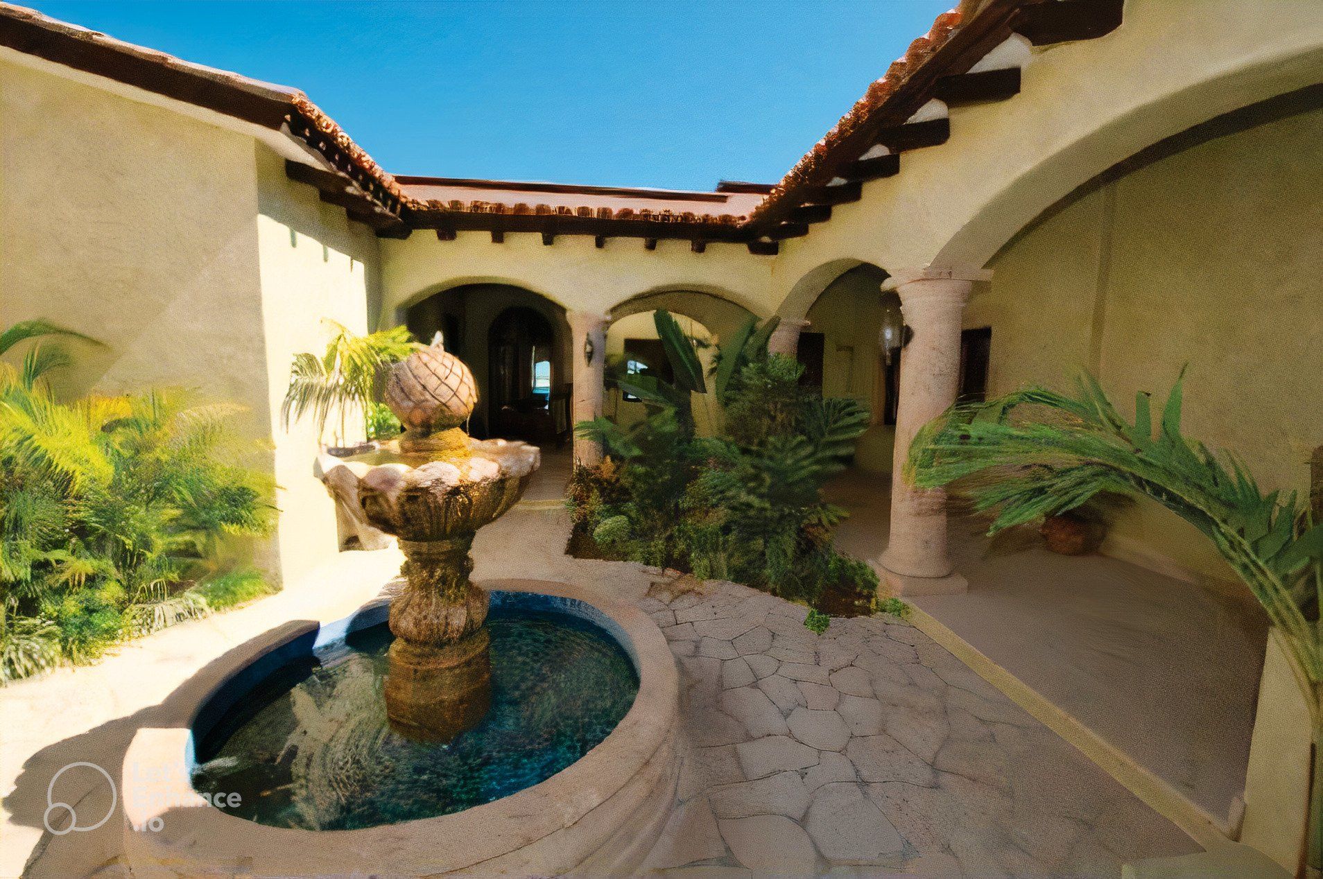 A courtyard with a fountain in the middle of it