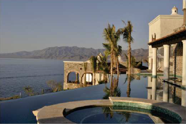 A large house with a swimming pool overlooking the ocean