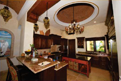 A kitchen with a chandelier hanging from the ceiling