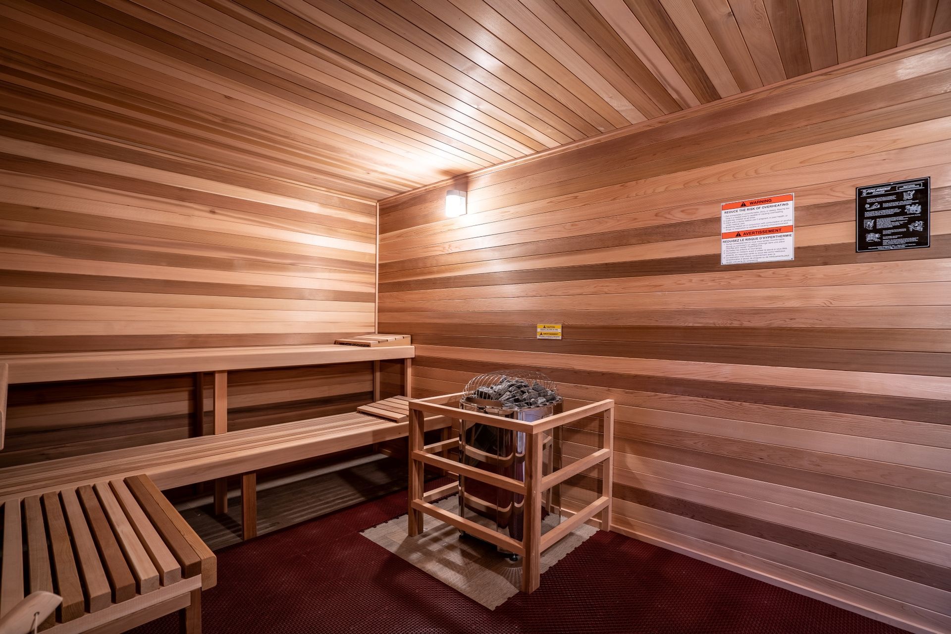 A wooden sauna with a heater and benches.
