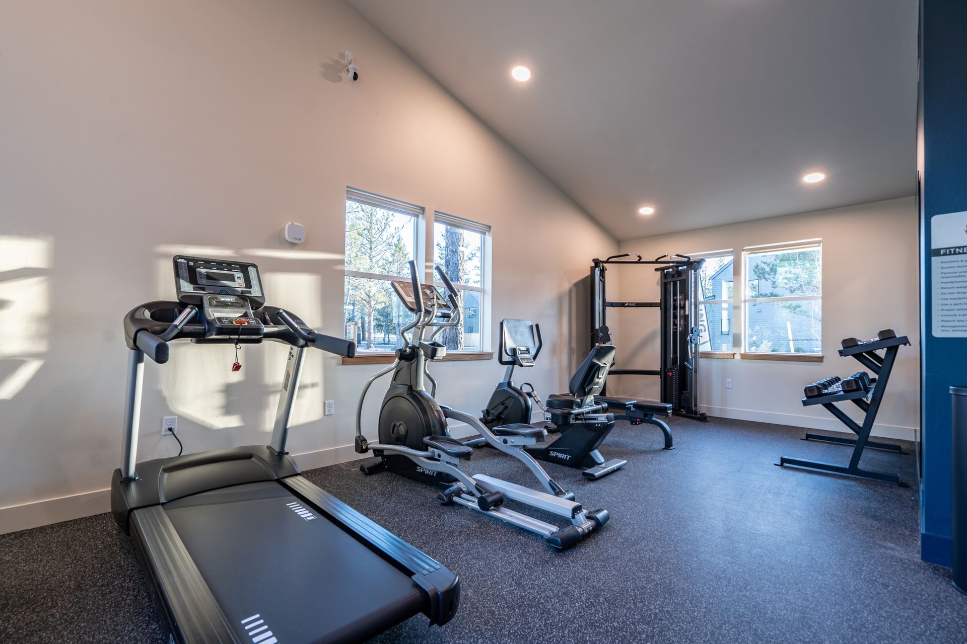 A gym with treadmills , ellipticals , and other exercise equipment.