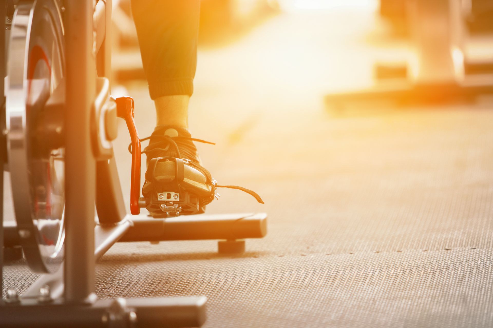 A person is riding an exercise bike in a gym.