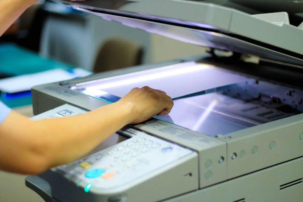 A Person is Using a Scanner to Scan a Piece of Paper — Print Spot Group in South Murwillumbah, NSW