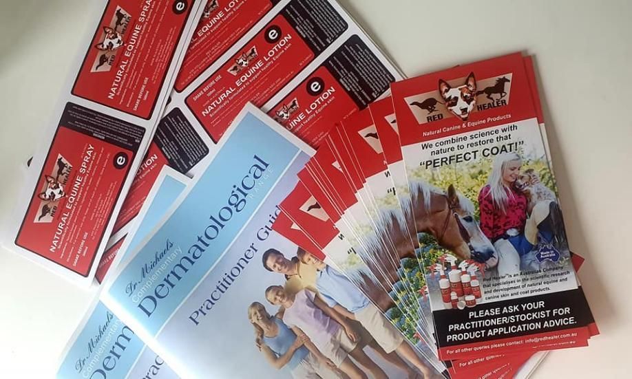 Red Flyers On Table — Print Spot Group In Tweed Heads, NSW