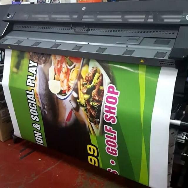 Green Tarpaulin On Printing Machine — Print Spot Group in South Murwillumbah, NSW