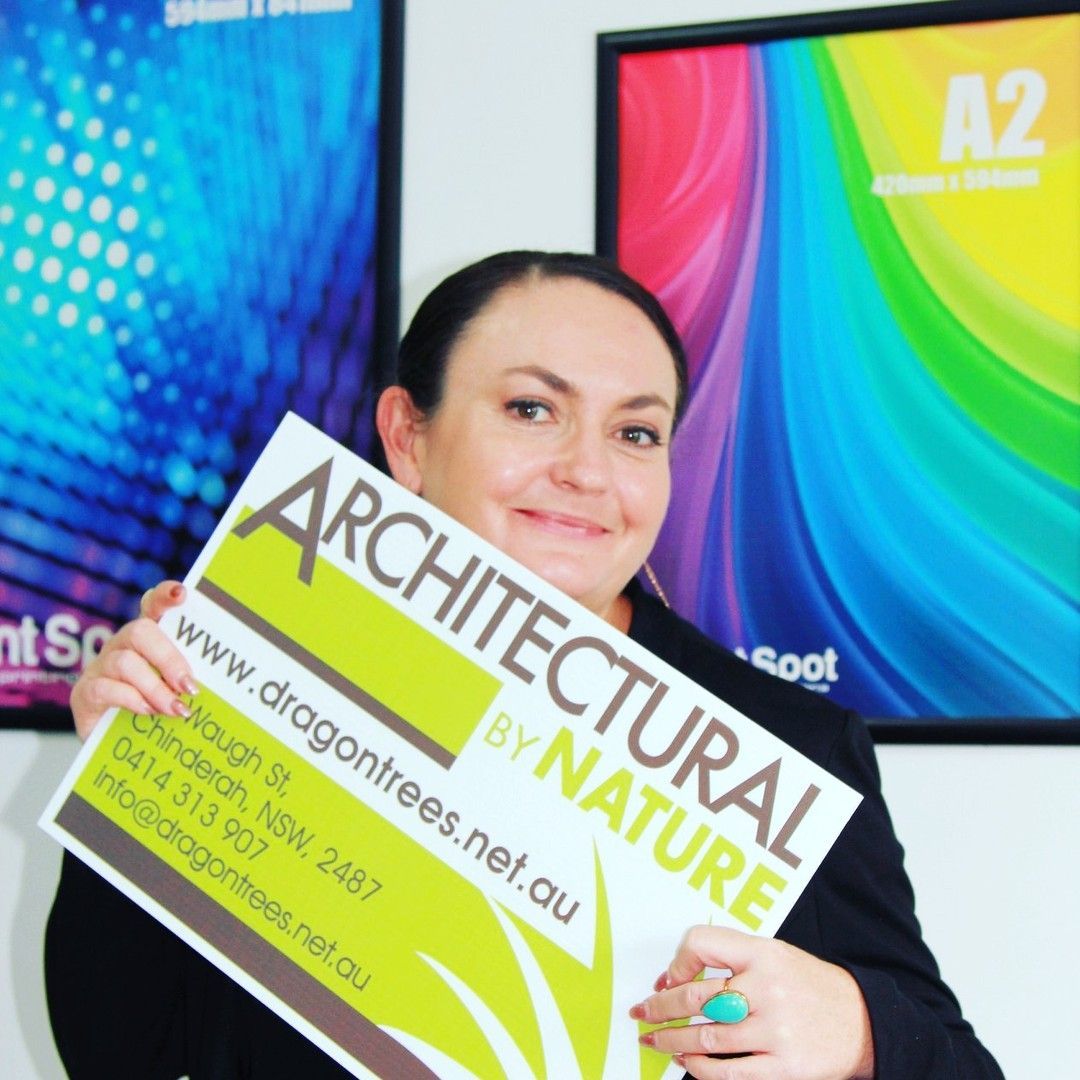 A Woman Holding a Sign— Print Spot Group in South Murwillumbah, NSW