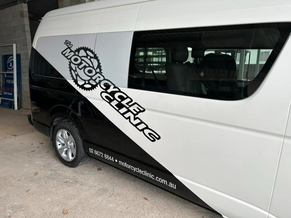 White Van Motorcycle Clinic On The Garage — Print Spot Group in South Murwillumbah, NSW