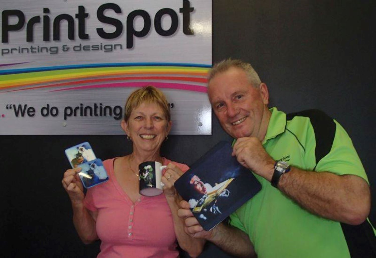 A Man and a Woman Are Standing in Front of a Sign — Print Spot Group in South Murwillumbah, NSW