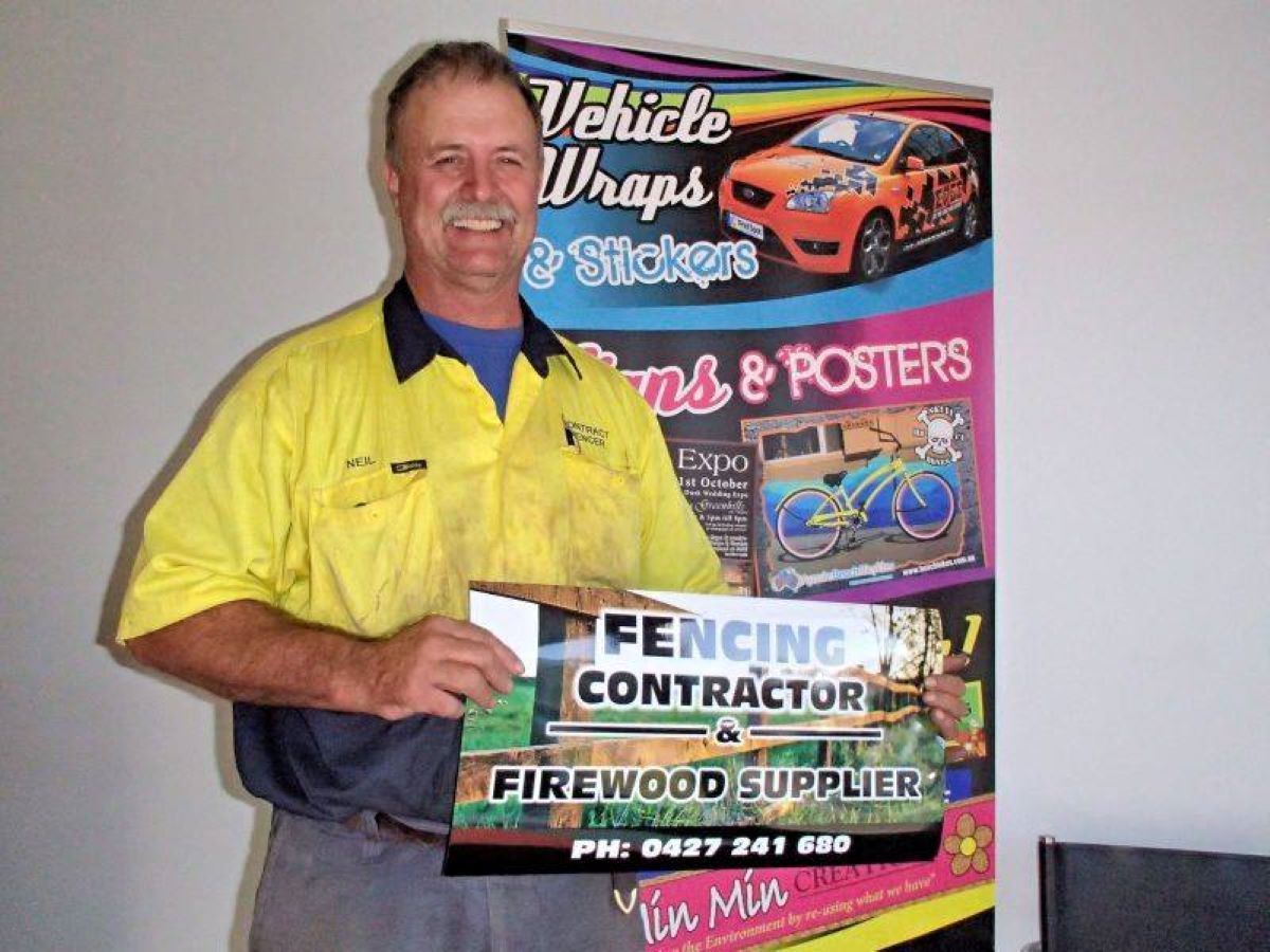 A Man Holding a Sign — Print Spot Group in South Murwillumbah, NSW