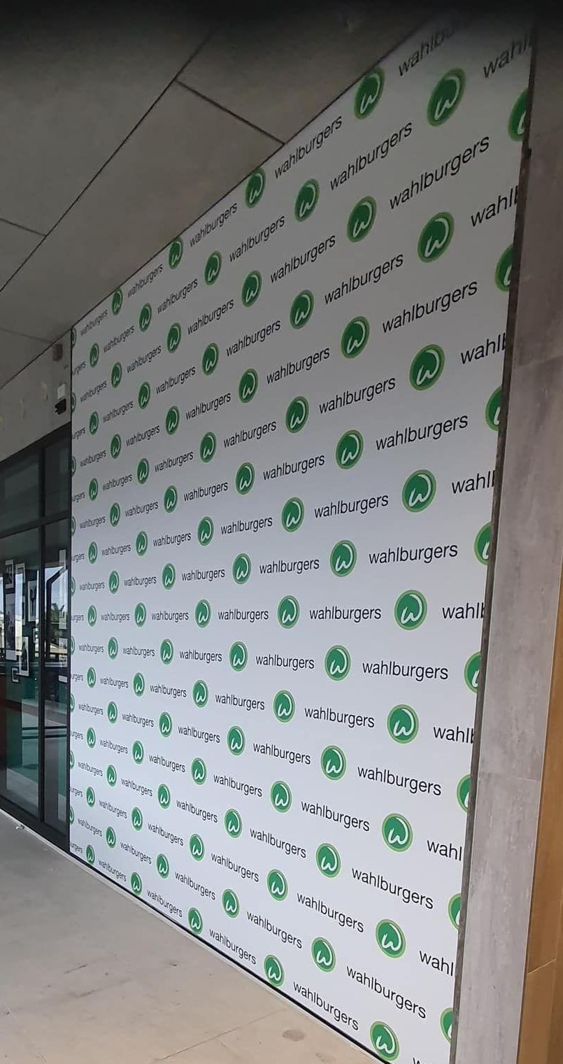 A Wall With a Lot of Green Circles on It — Print Spot Group In Kingscliff, NSW
