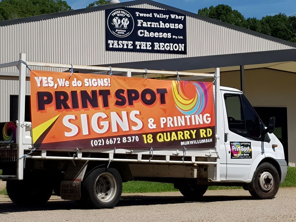 A White Truck is Parked in Front of a Building — Print Spot Group in Byron Bay, NSW