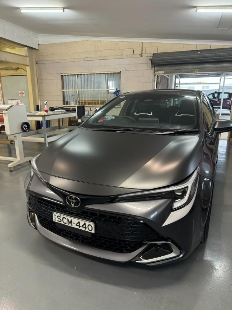 Matte Black Car In The Garage — Print Spot Group in Kingscliff, NSW