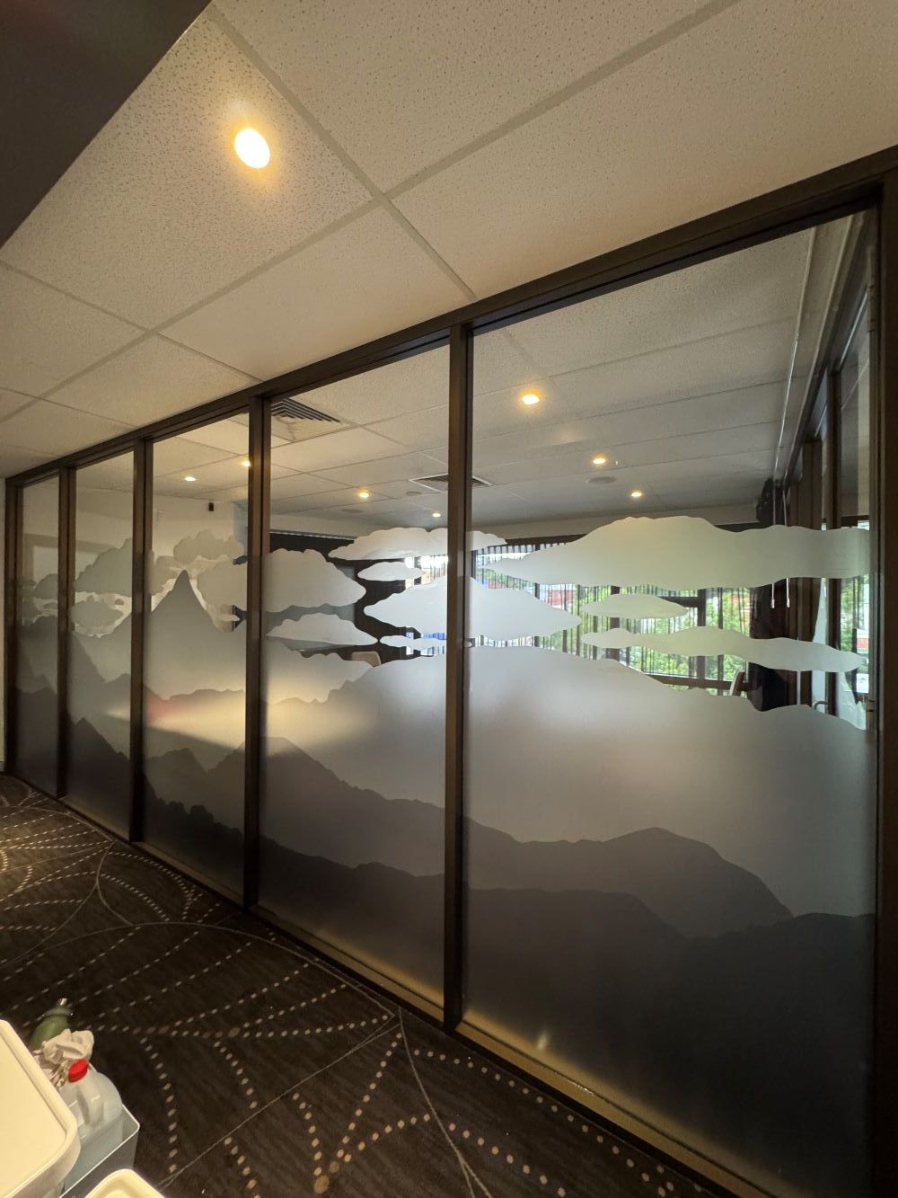 A printed sign is being placed in front of the door — Print Spot Group in South Murwillumbah, NSW