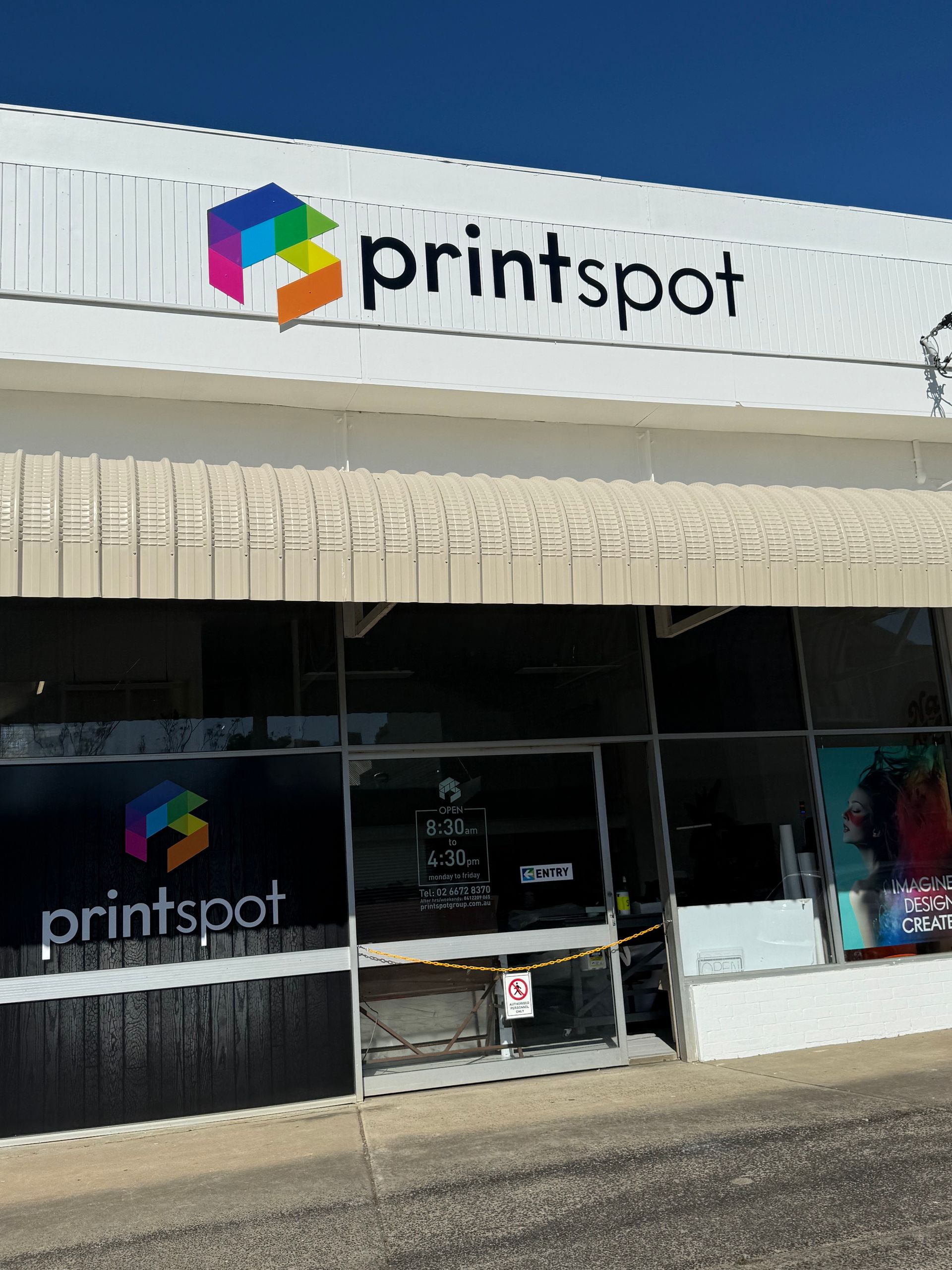 Three Flags Are Flying in Front of a Building — Print Spot Group in Tweed Heads, NSW