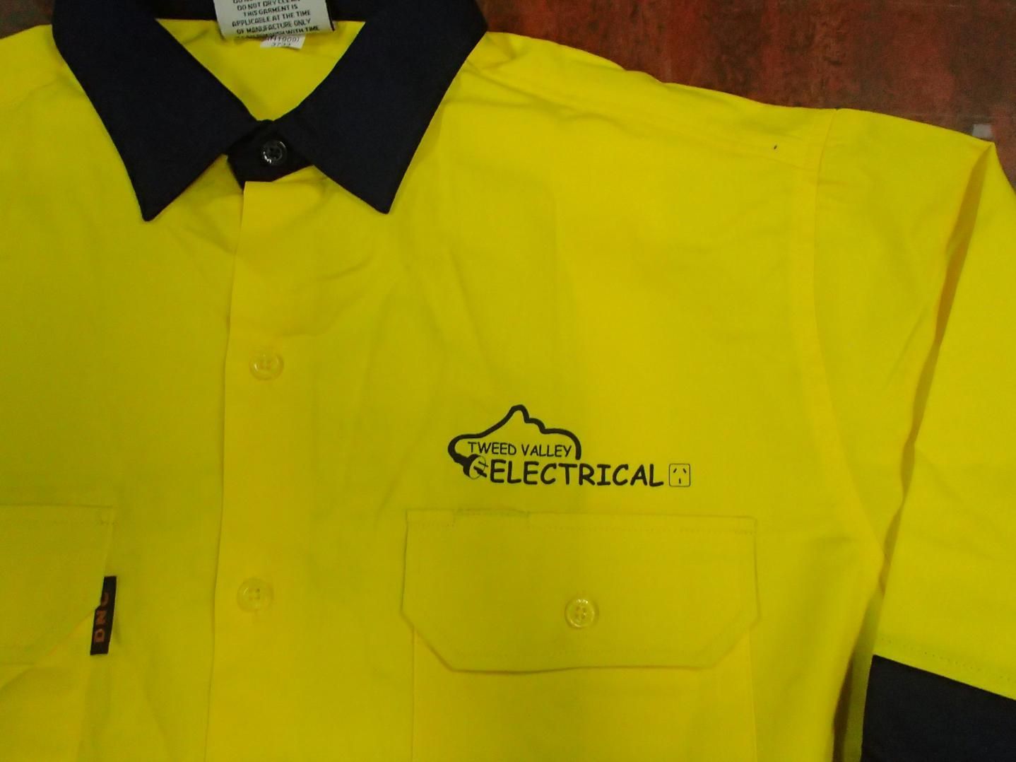 Yellow Shirt With Company's Logo — Print Spot Group in South Murwillumbah, NSW