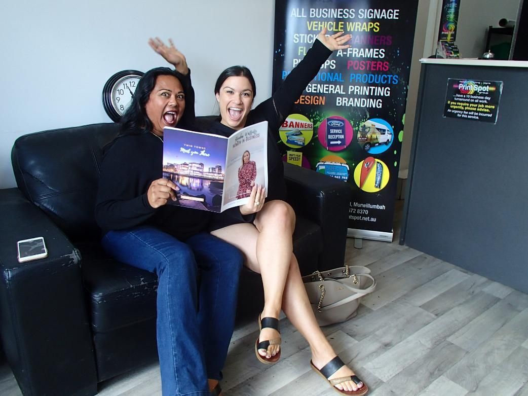 Women Sitting On A Couch Promoting Their Book — Print Spot Group in South Murwillumbah, NSW