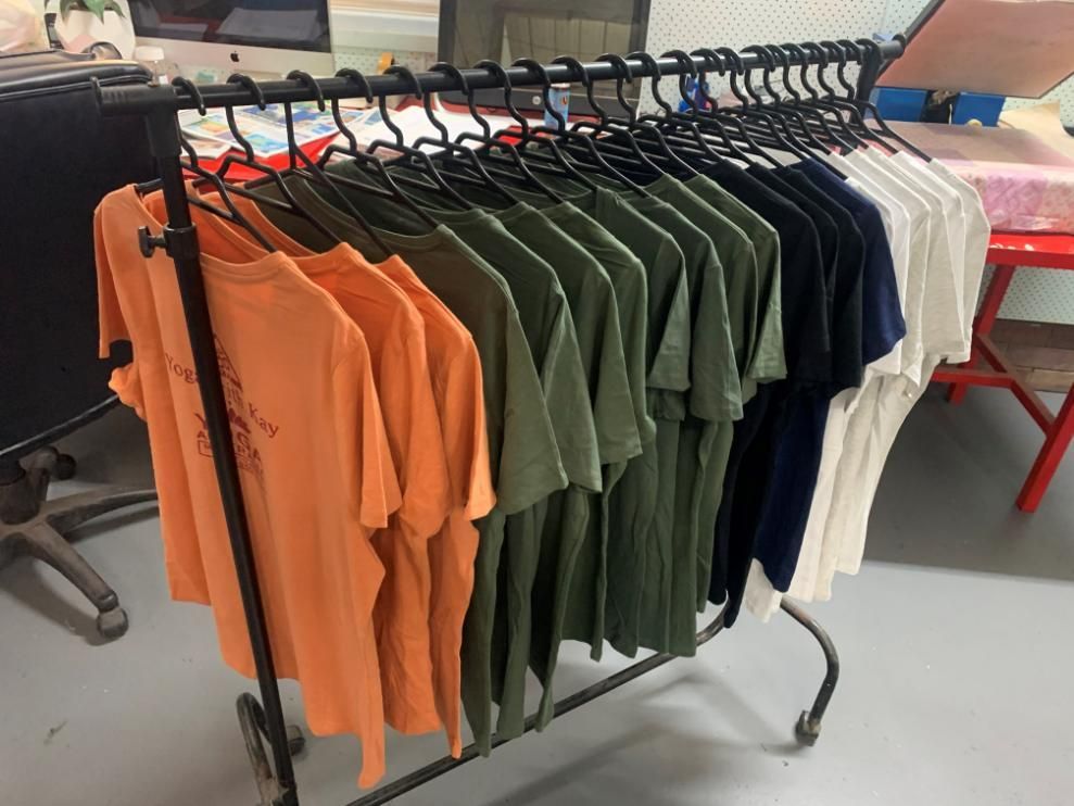 Row Of Clothes Hanging On The Rack — Print Spot Group In Tweed Heads, NSW