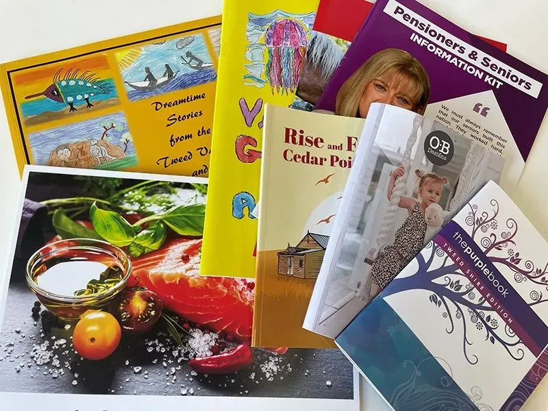 A Bunch of Books Are Stacked on Top of Each Other — Print Spot Group In Murwillumbah, NSW