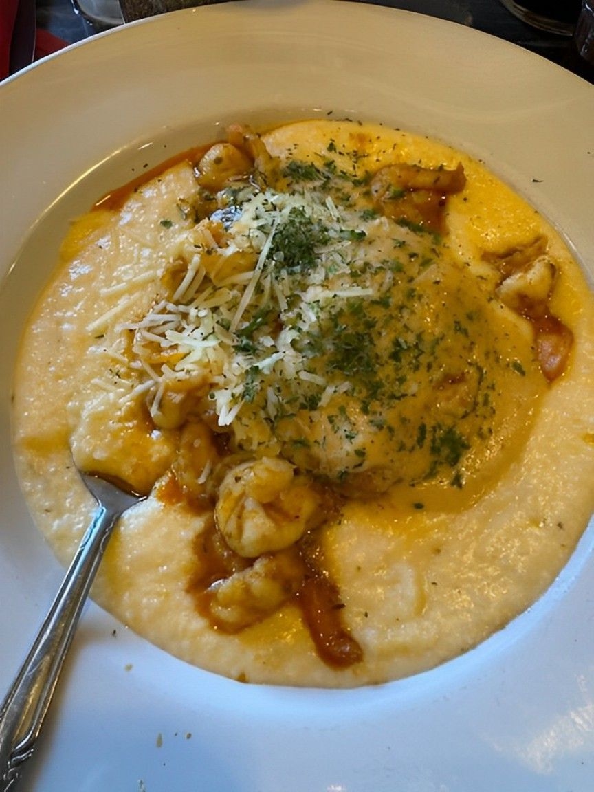 a person is holding a plate of food in their hand .