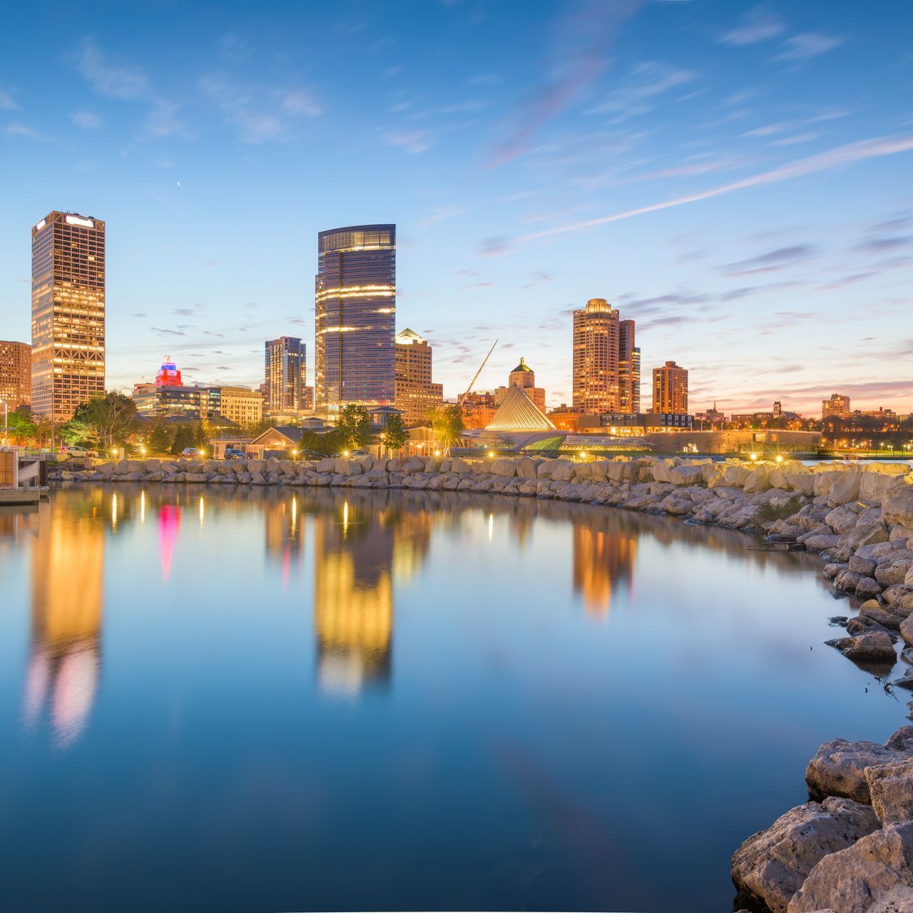 A city skyline is reflected in a body of water