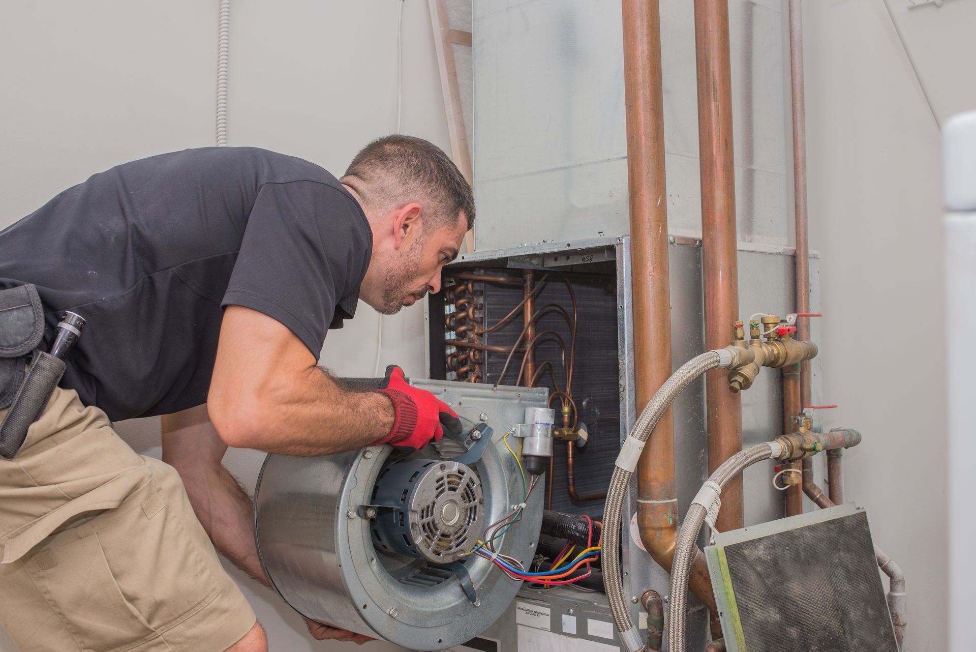 Hvac technition removing motor to examine coils - commercial hvac coil cleaning