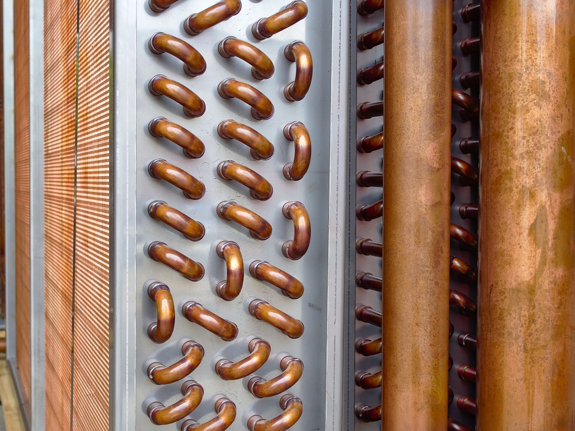 Close up shot of copper plain tubes of a condenser coil - commercial coil cleaning process