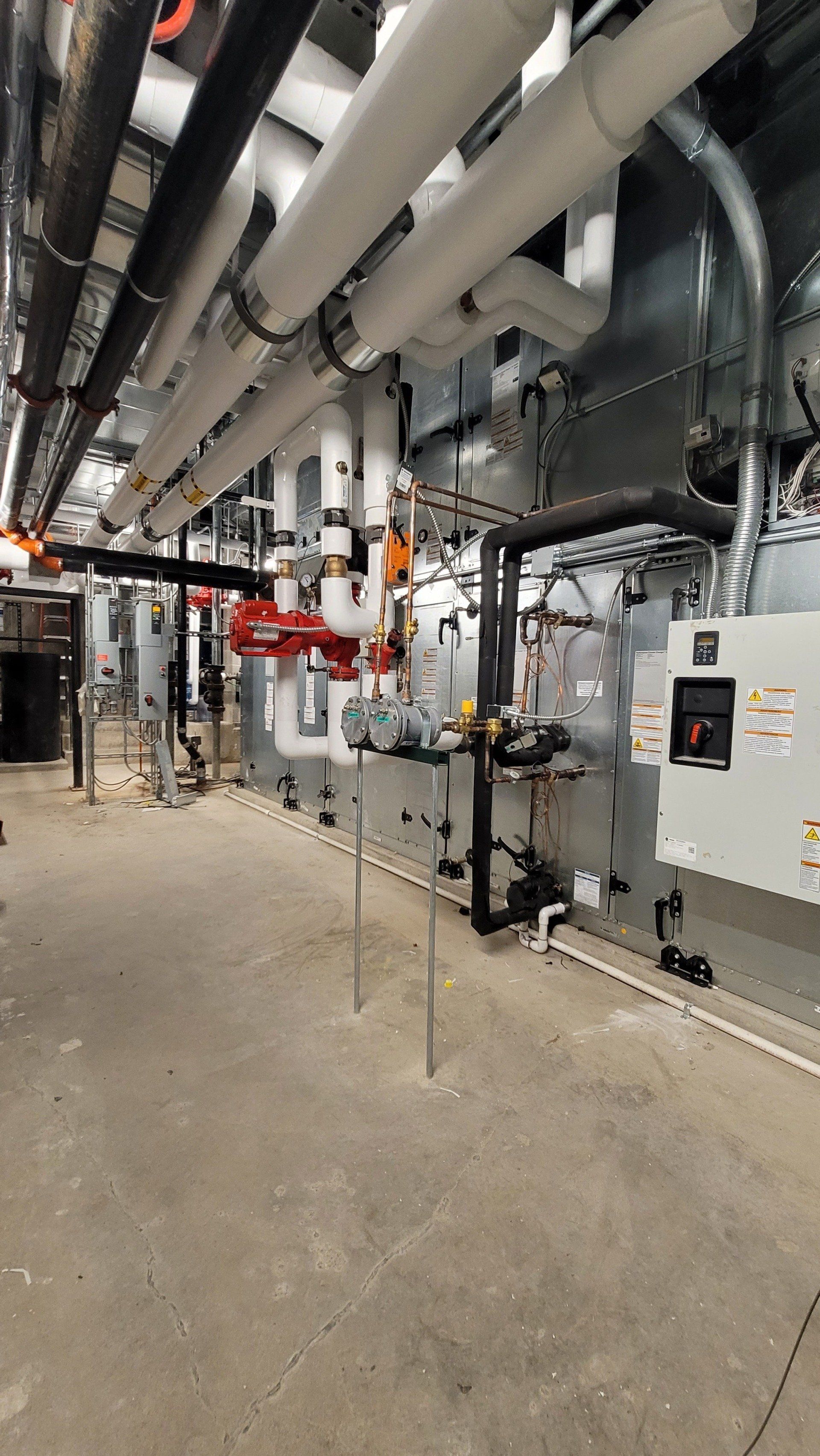 A large room filled with lots of pipes and machinery.