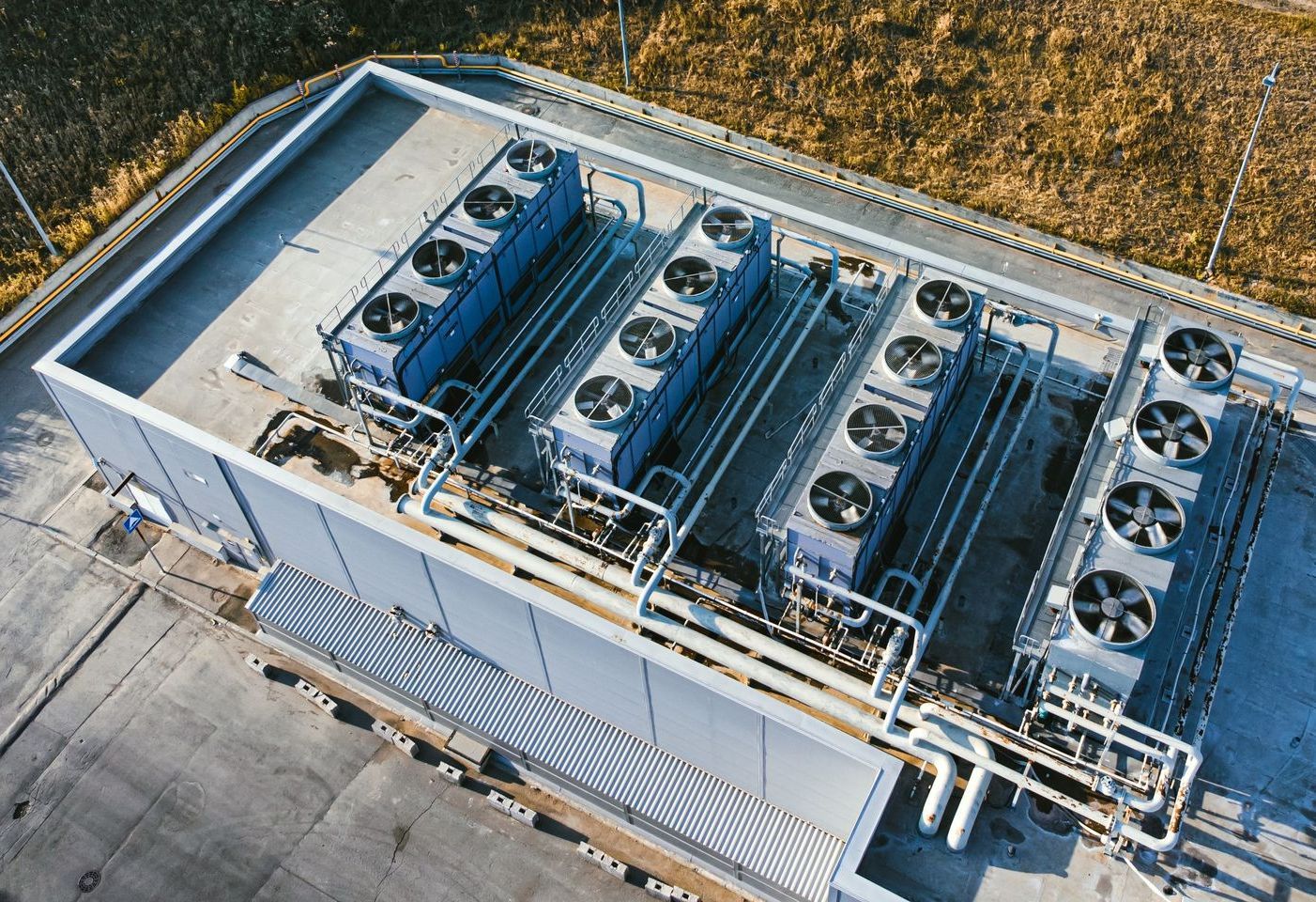 an aerial view of a large building with a lot of fans on the roof - HVAC building control