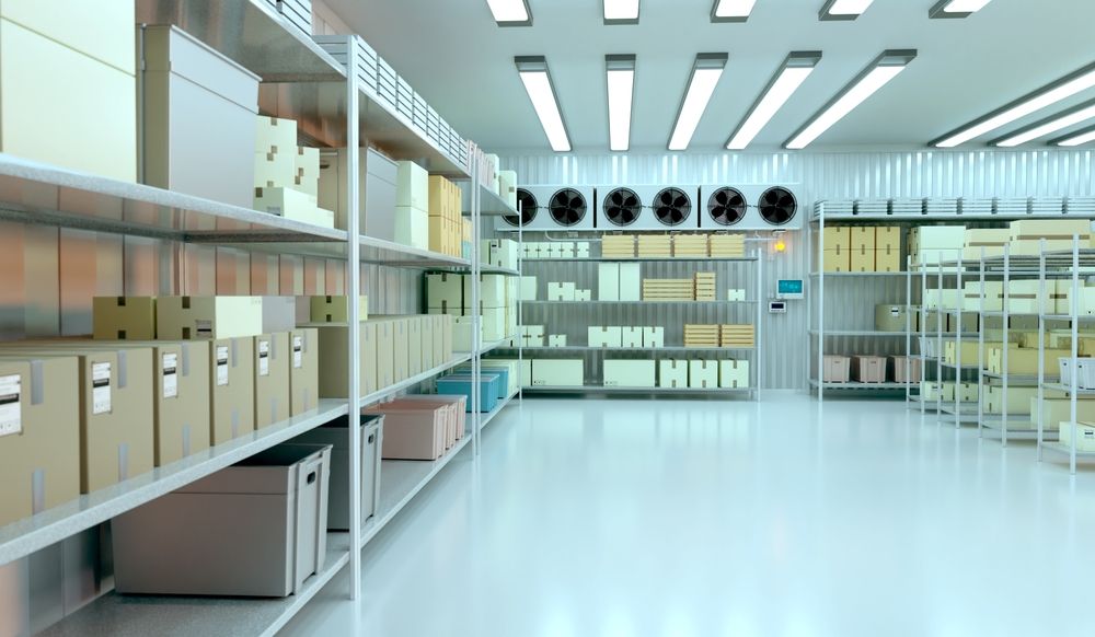 A refrigerator warehouse filled with lots of shelves and boxes.