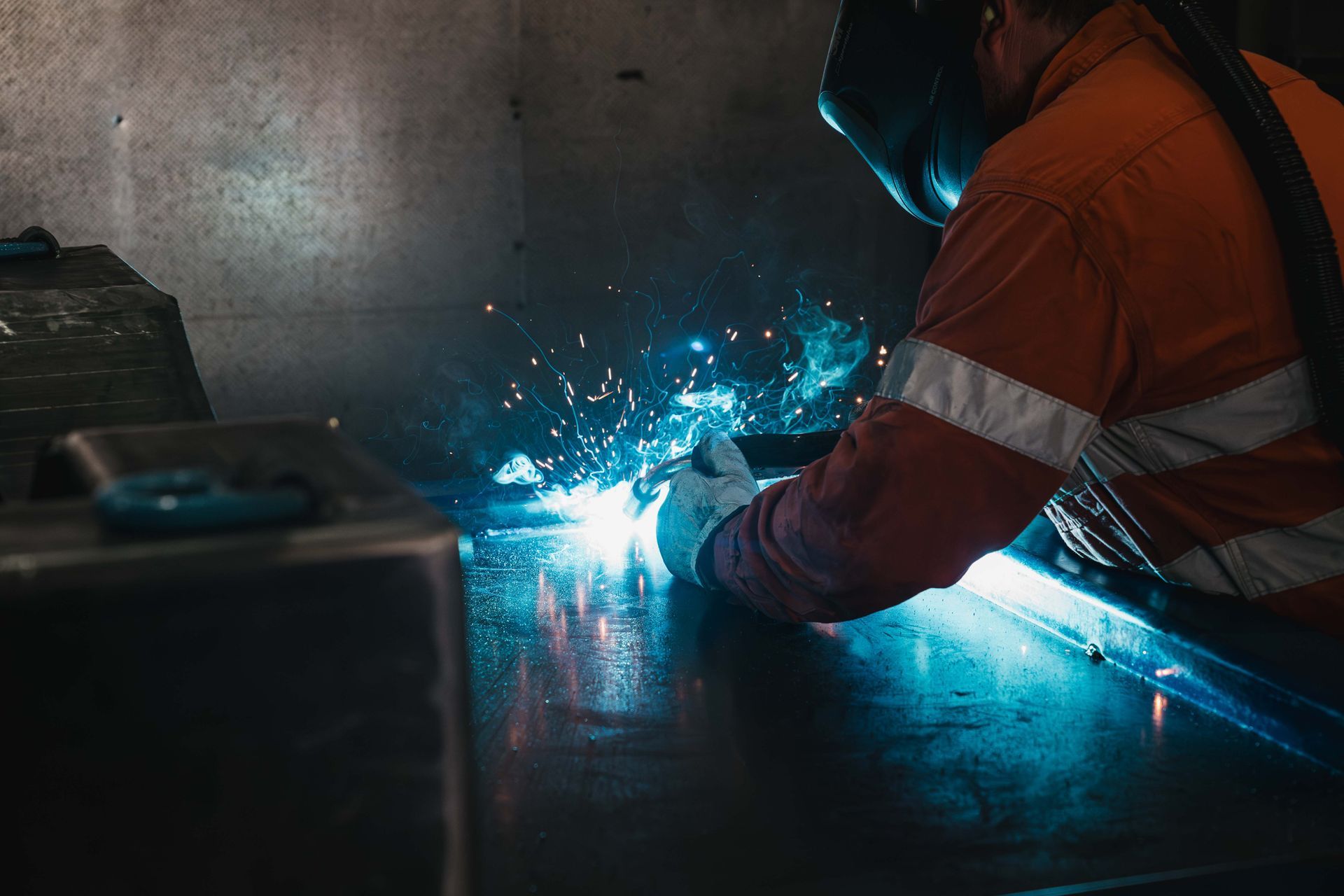 A Person Is Welding a Piece of Metal in a Factory | Orange, NSW | Whittaker Contracting