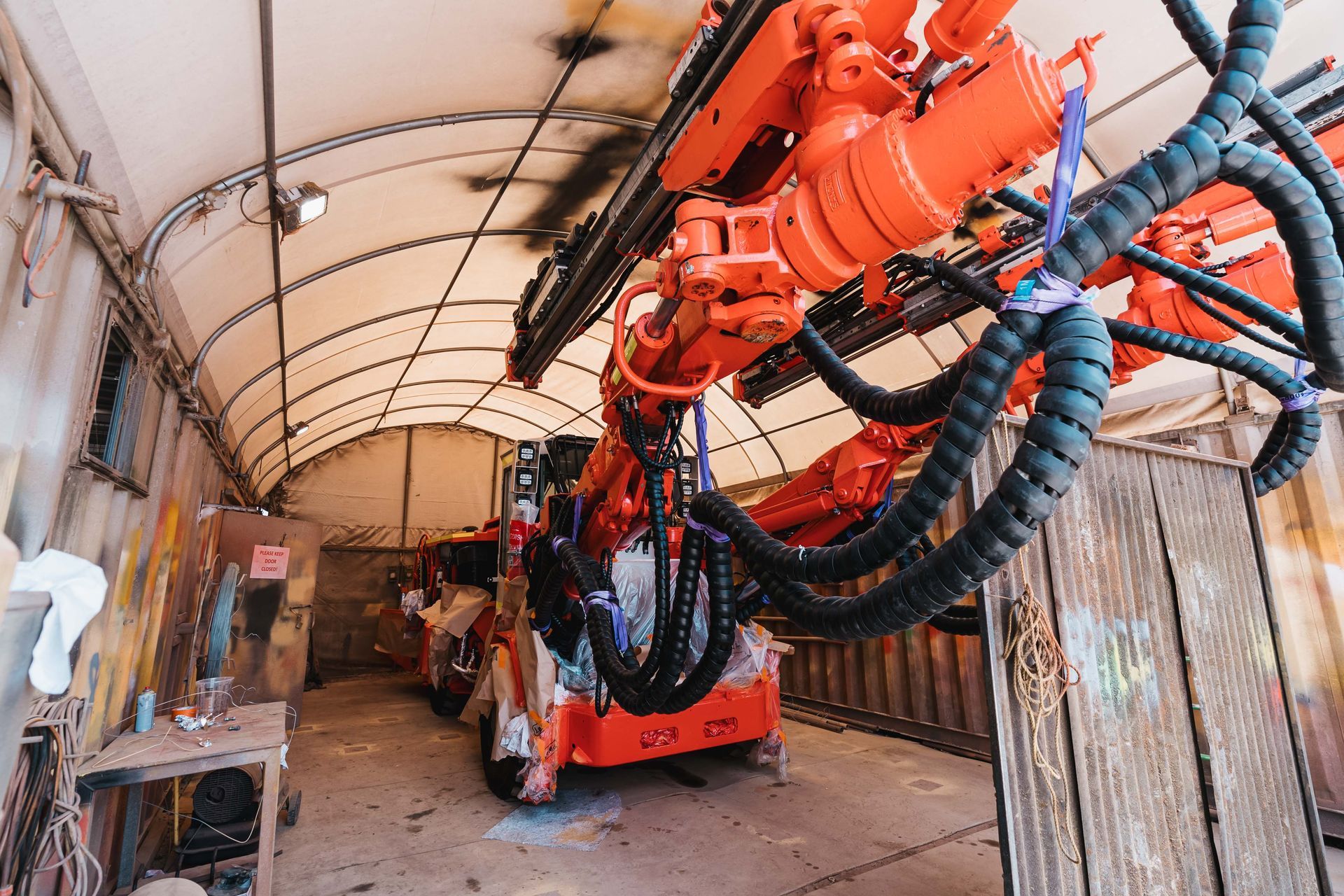 A Large Orange Machine Is Sitting in a Garage | Orange, NSW | Whittaker Contracting