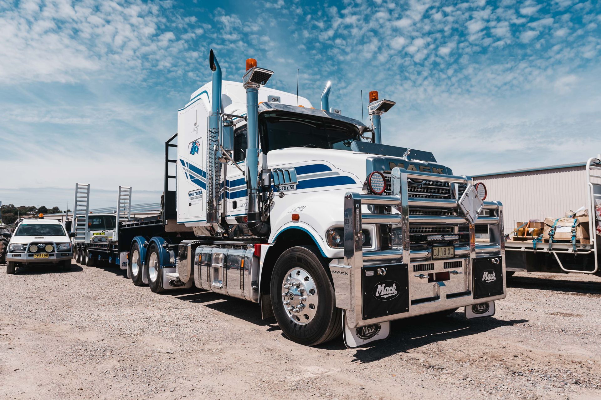 A White Truck Is Sitting on a Lift in a Garage | Orange, NSW | Whittaker Contracting