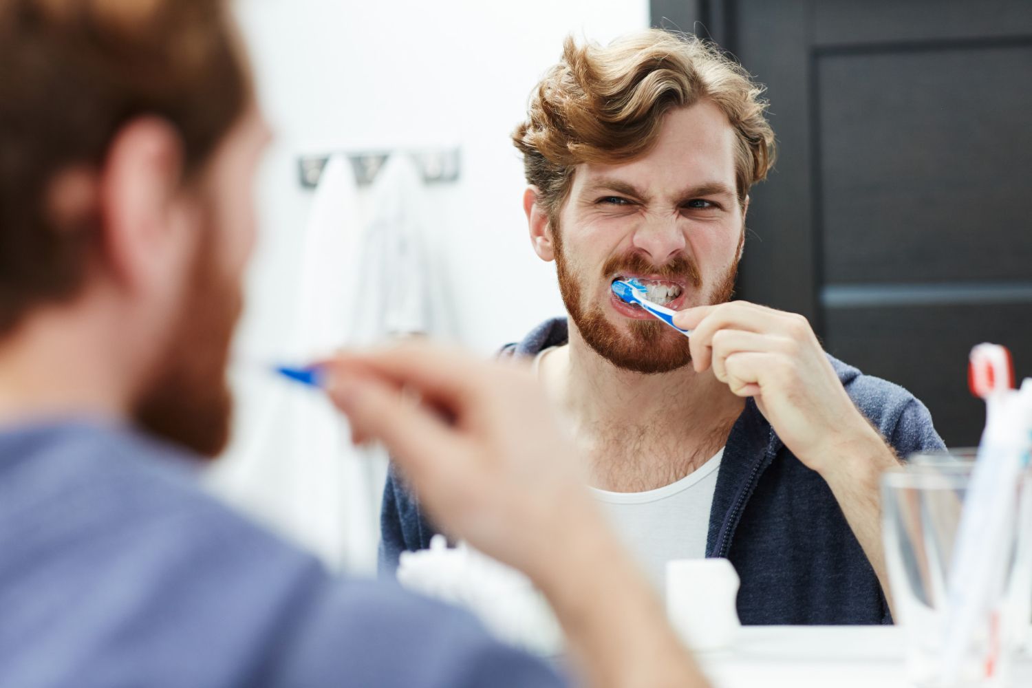 man brushing teeth