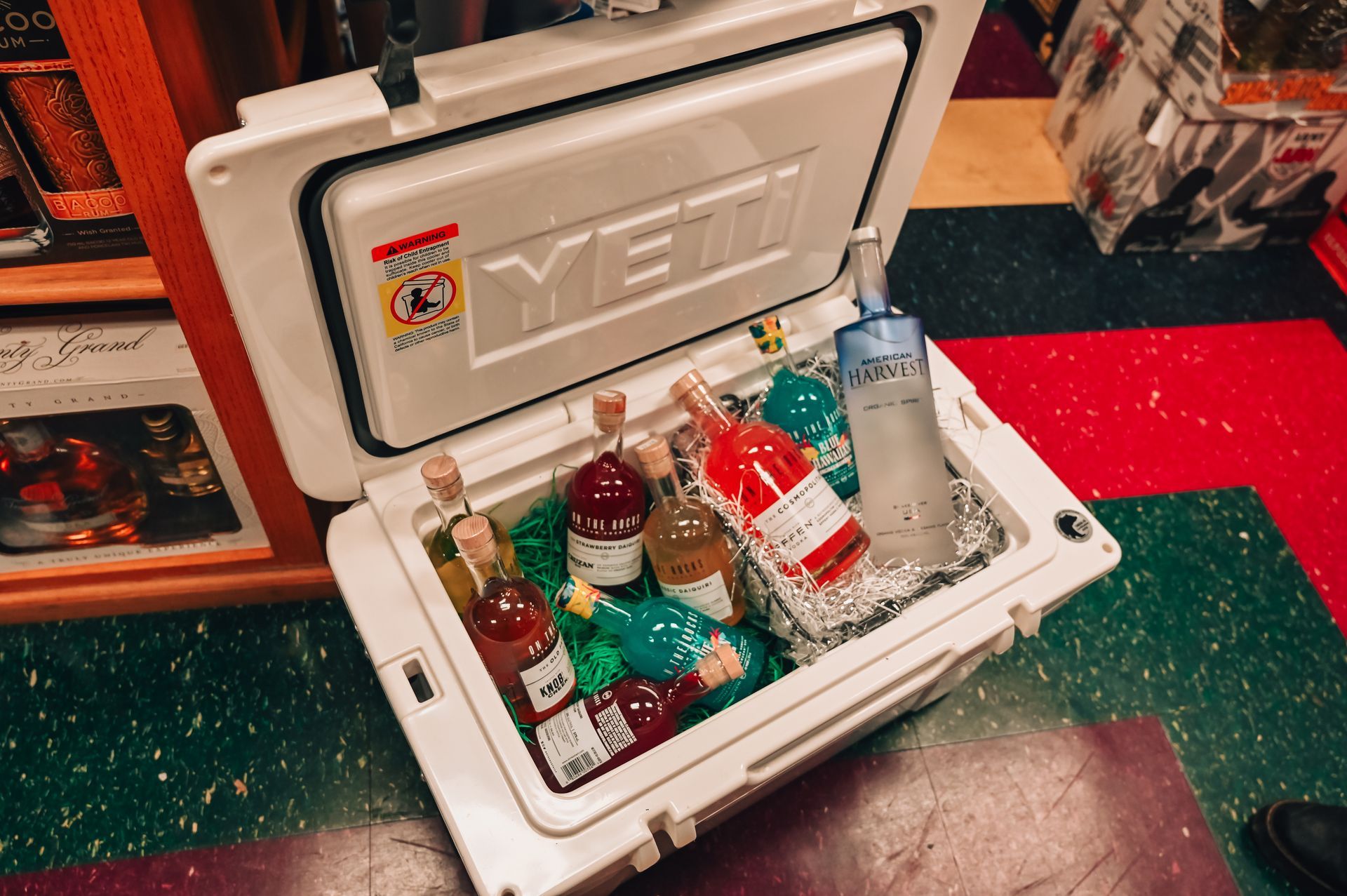 A Yeti cooler with a variety of bottles inside.