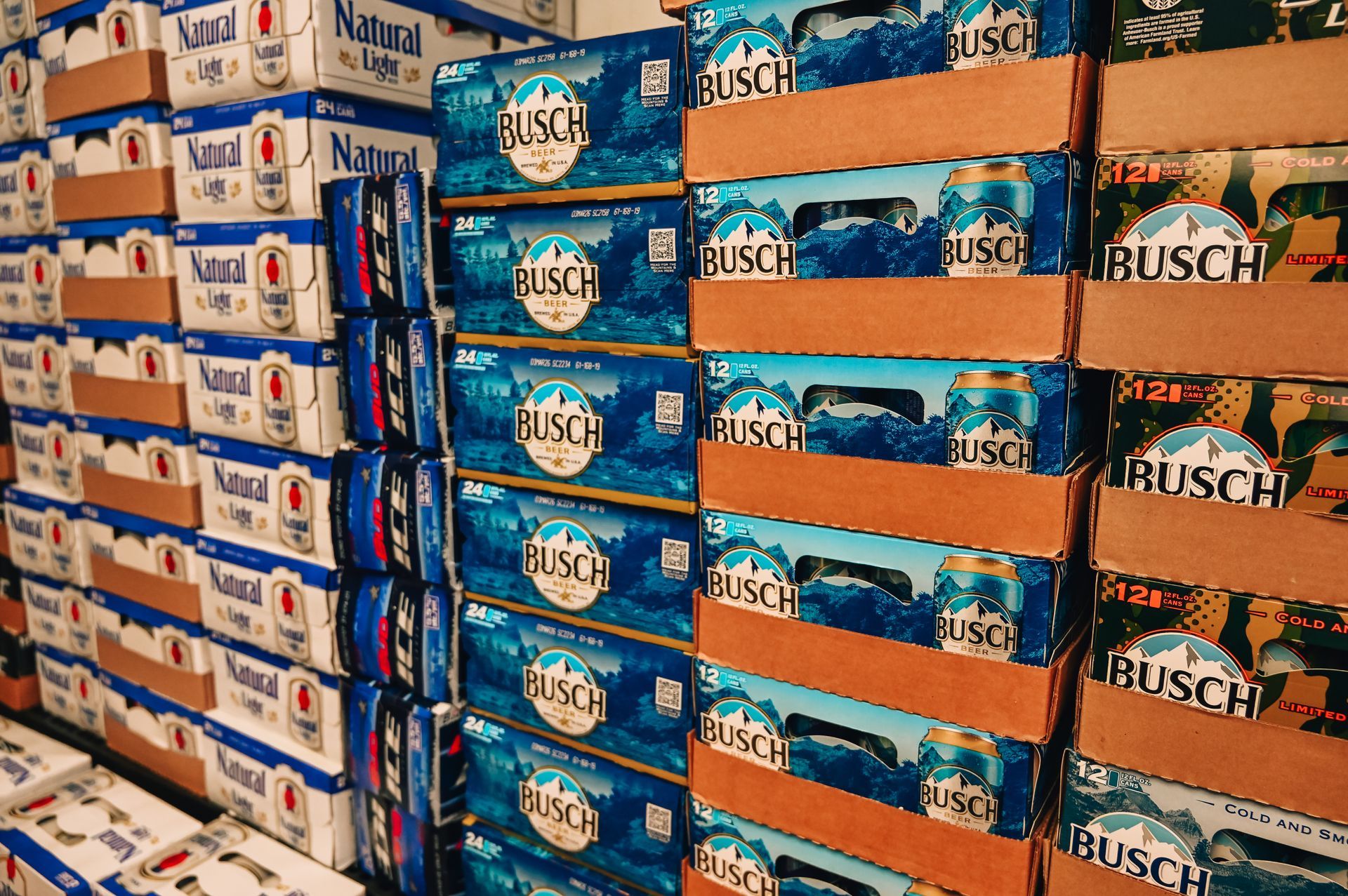 Stacks of Busch and Natural Light beer cases in a storage area.