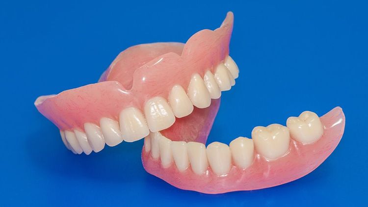 complete set of freshly repaired and polished dentures