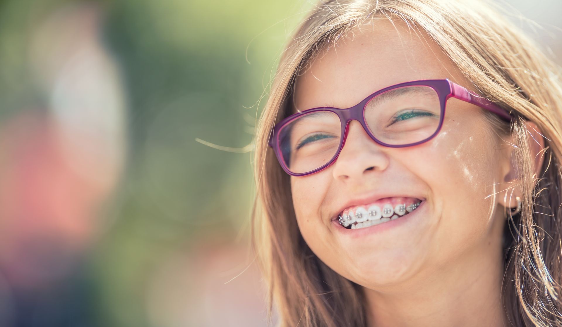 A happy, smiling teenage girl with braces