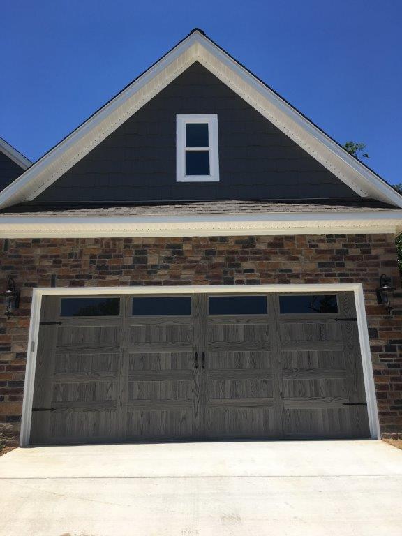 House With Brick Wall And Wooden Garage Door — Sherwood, AR — Harmon Overhead Door