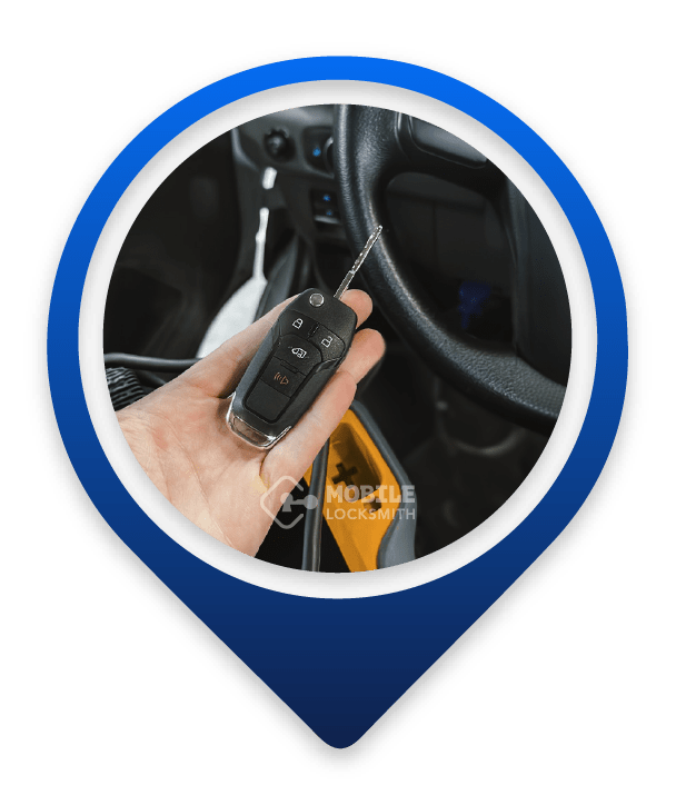 A Close-Up Of A Car Locksmith's Hand Holding A Car Key Fob.