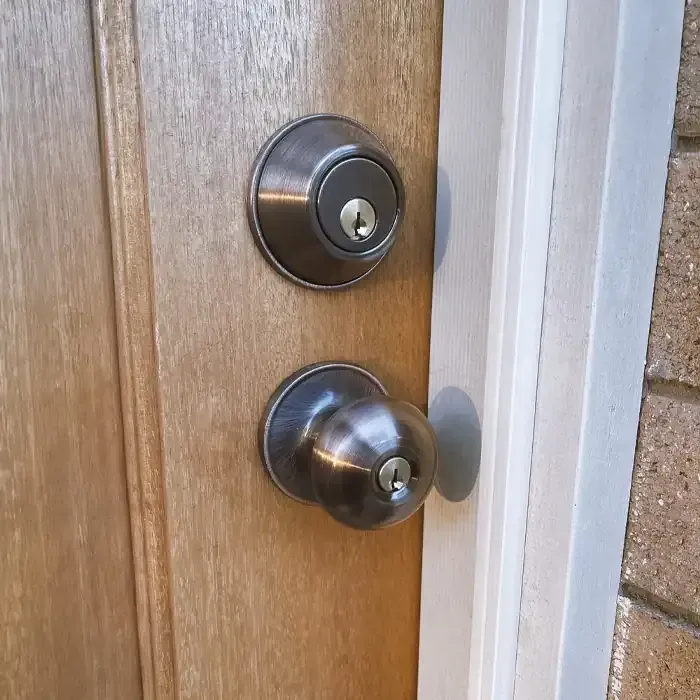 A Brown Door With Knob And Deadbolt For Home Security. A Brown Door With Knob And Deadbolt For Home Security.